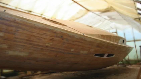 Refinished sailboat hull prepared for launch